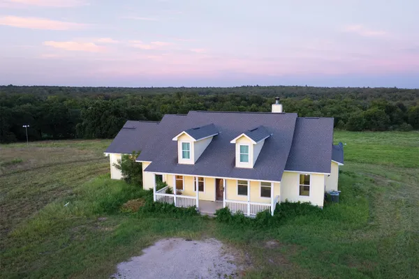 an aerial view of residential house with green space