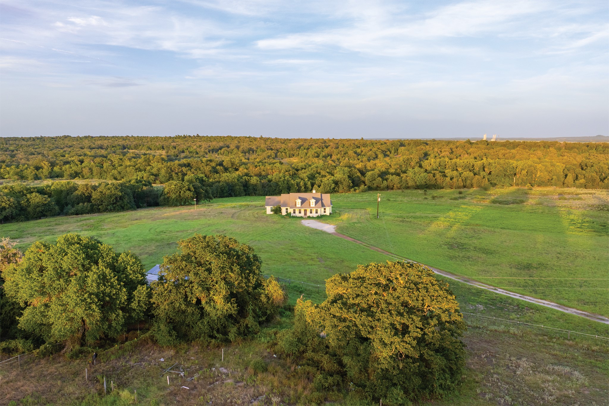 498 North County Line Road Elgin, TX 78621 - Photo 22 of 40 View of property location with a heavily wooded area and rural landscape