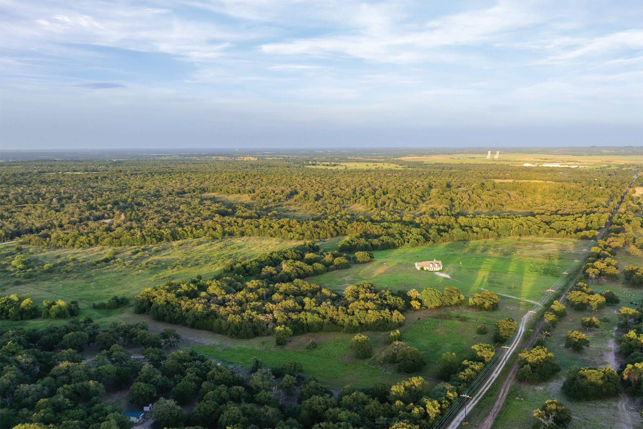 498 North County Line Road Elgin, TX 78621 - Photo 24 of 40 Aerial overview of property's location featuring a heavily wooded area