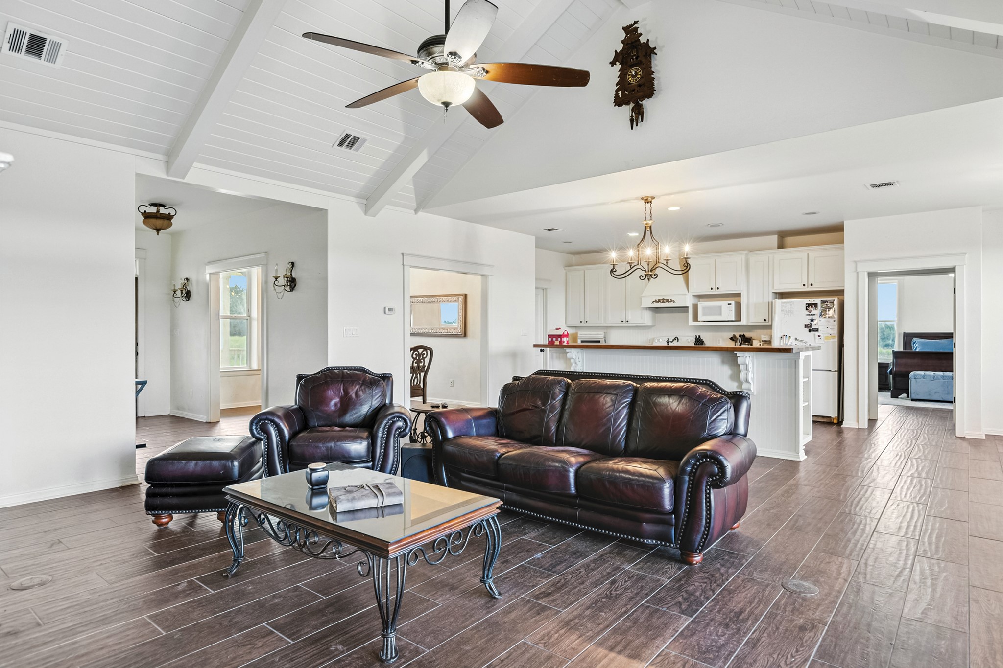 498 North County Line Road Elgin, TX 78621 - Photo 29 of 40 Living room with beamed ceiling, a chandelier, dark wood-type flooring, high vaulted ceiling, and ceiling fan