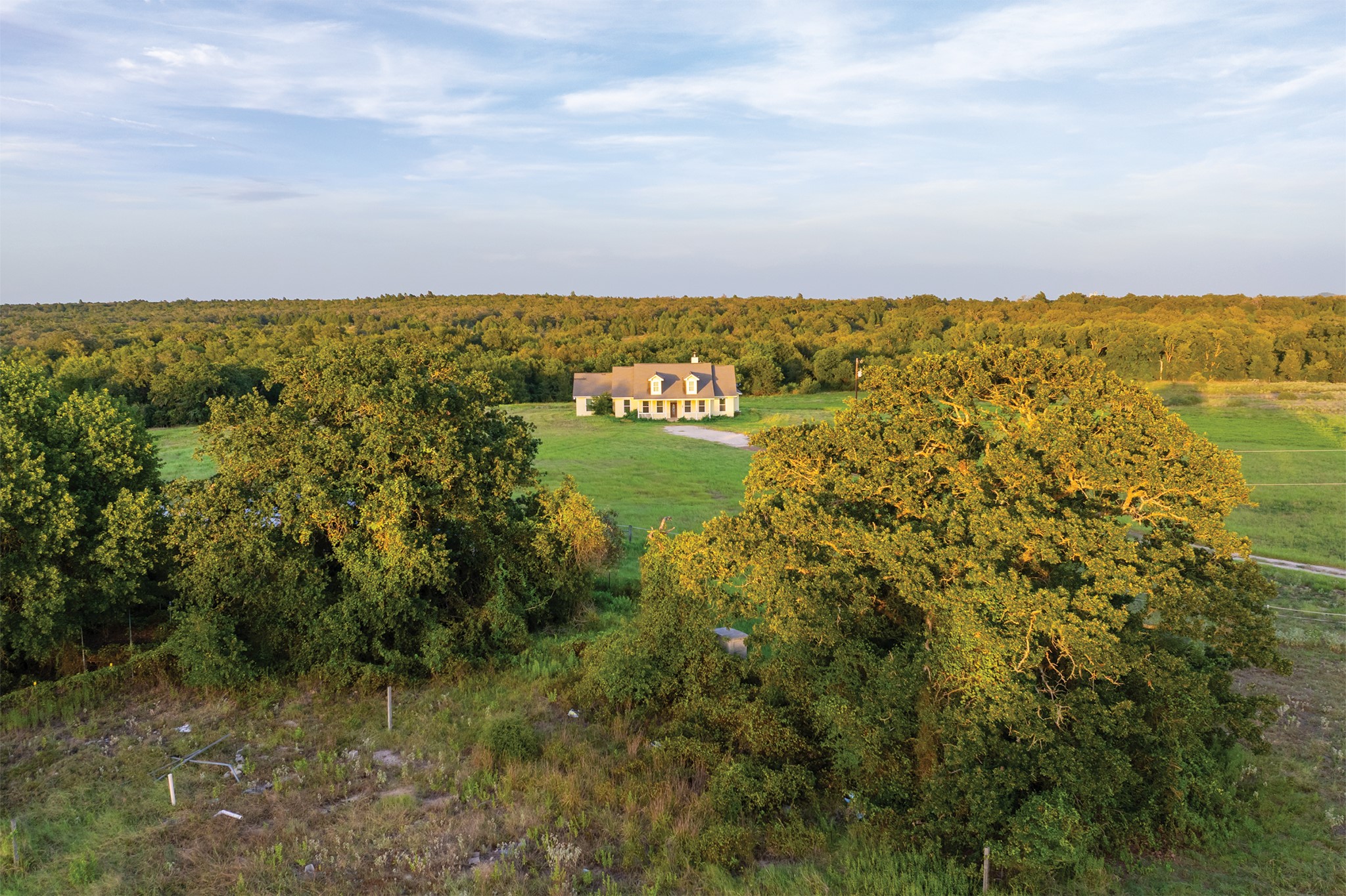498 North County Line Road Elgin, TX 78621 - Photo 3 of 40 Aerial view of property and surrounding area with a heavily wooded area