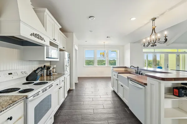 a kitchen with kitchen island granite countertop lots of counter space and stainless steel appliances