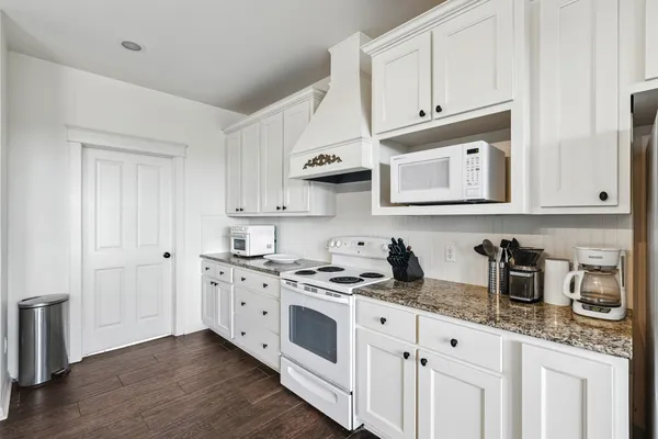 a view of a kitchen center island and stainless steel appliances