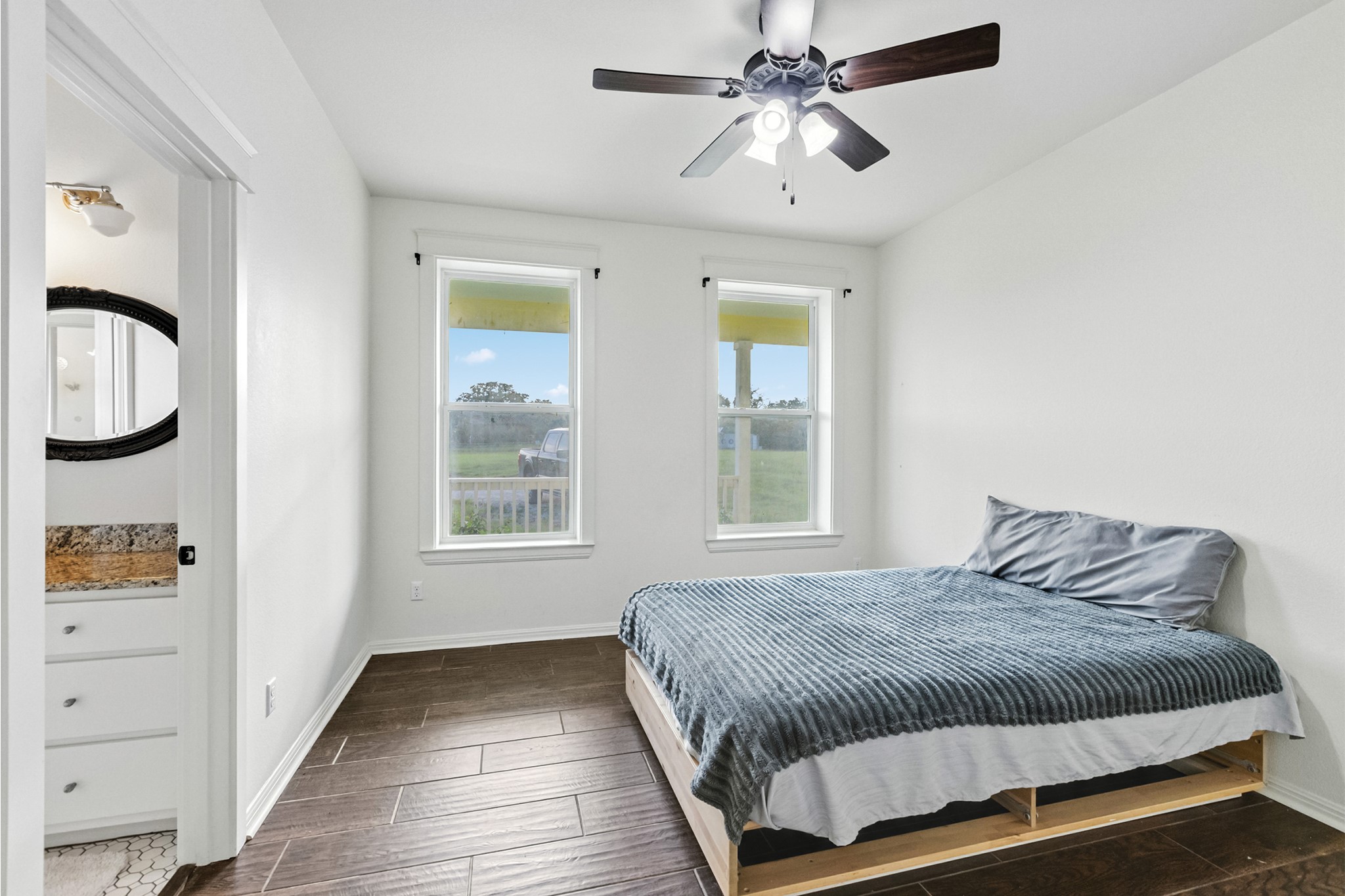 498 North County Line Road Elgin, TX 78621 - Photo 37 of 40 Bedroom featuring wood tiled floors and ceiling fan