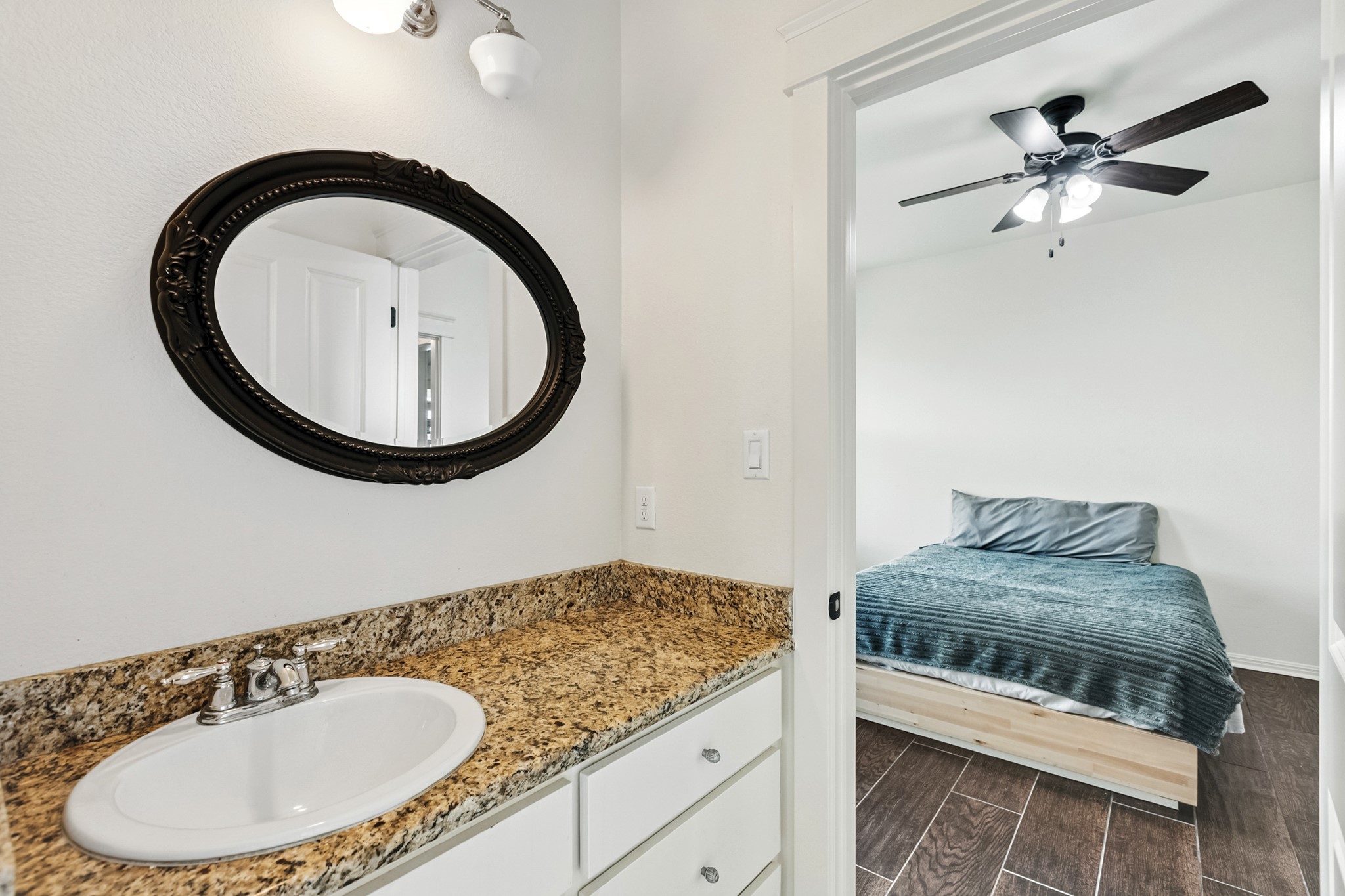 498 North County Line Road Elgin, TX 78621 - Photo 38 of 40 Bathroom with wood tiled floors, vanity, and a ceiling fan