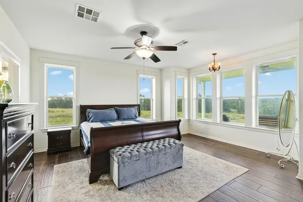 a bed room with a bed and a chandelier