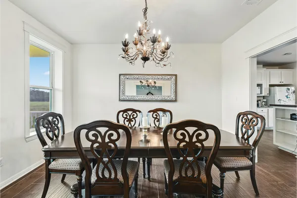 a view of a dining room with furniture and chandelier