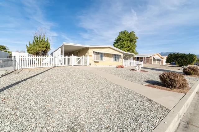 a view of a house with a yard and a garage