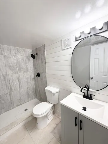 a bedroom with a bed potted plant and a window