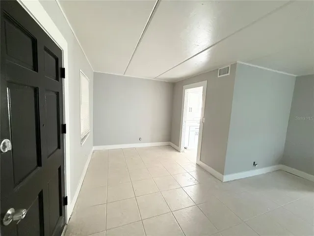 a view of an empty room and a window