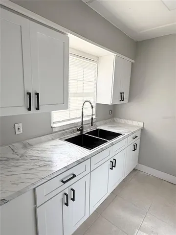 a kitchen with stainless steel appliances granite countertop a sink a stove and a microwave