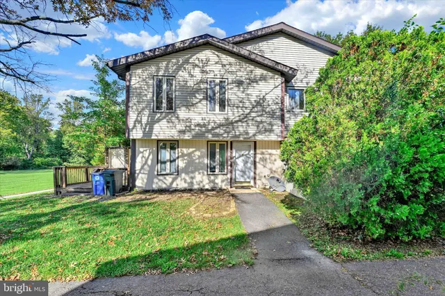 a view of a house with a yard porch and sitting area