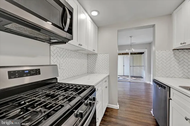 a stove top oven sitting inside of a kitchen