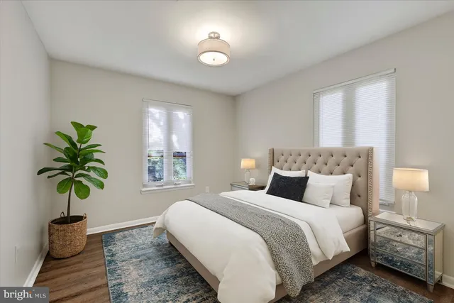 a bedroom with a bed and a potted plant