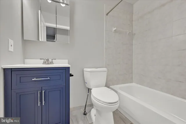 a bathroom with a sink a toilet and bathtub