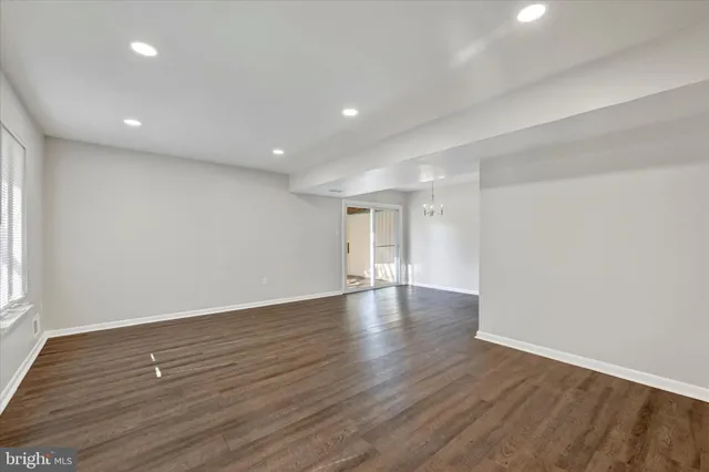a view of wooden floor and windows in a room