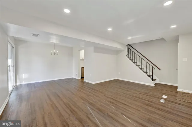 a view of an empty room with wooden floor