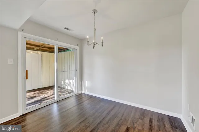 a view of a room with wooden floor and white walls