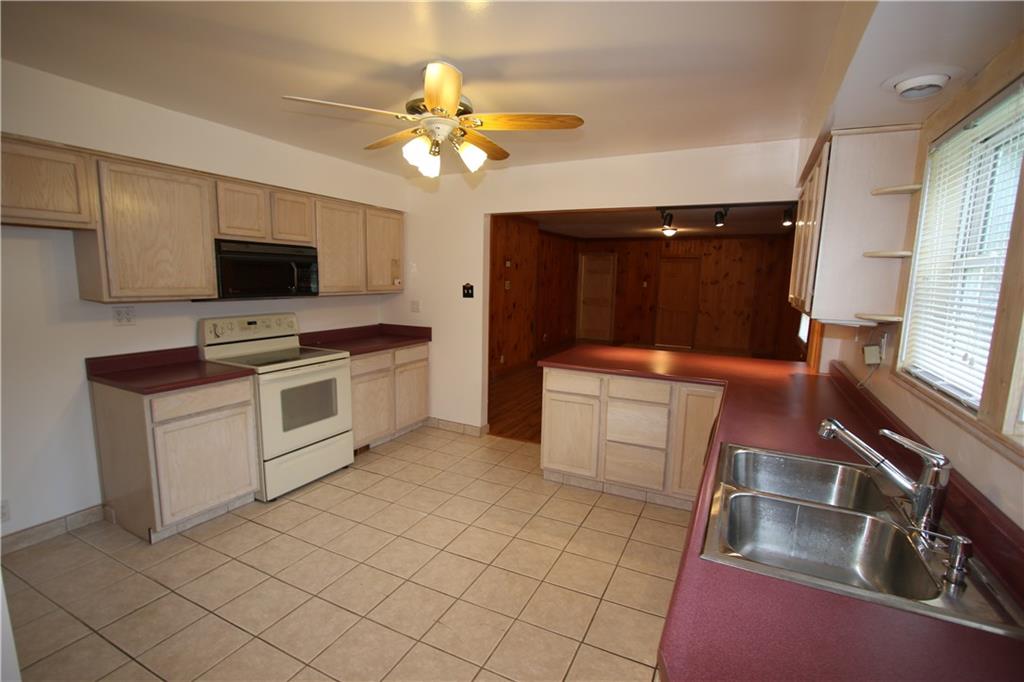 Electric Stove, Microwave, Dishwasher, Double Bowl Stainless Steel Sink & Newer Ceiling Fan Light all included in sale