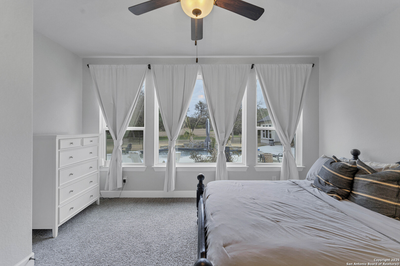 1033 Mystic Shores Boulevard Spring Branch, TX 78070 - Photo 11 of 39 a bedroom with a bed and large windows