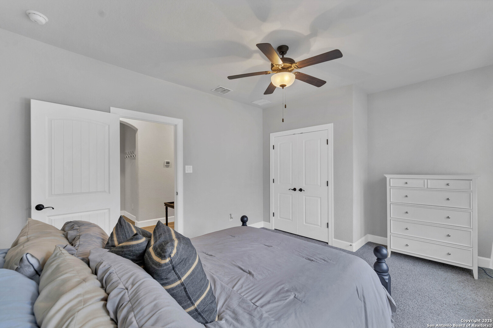 1033 Mystic Shores Boulevard Spring Branch, TX 78070 - Photo 12 of 39 a bedroom with a bed and a chandelier