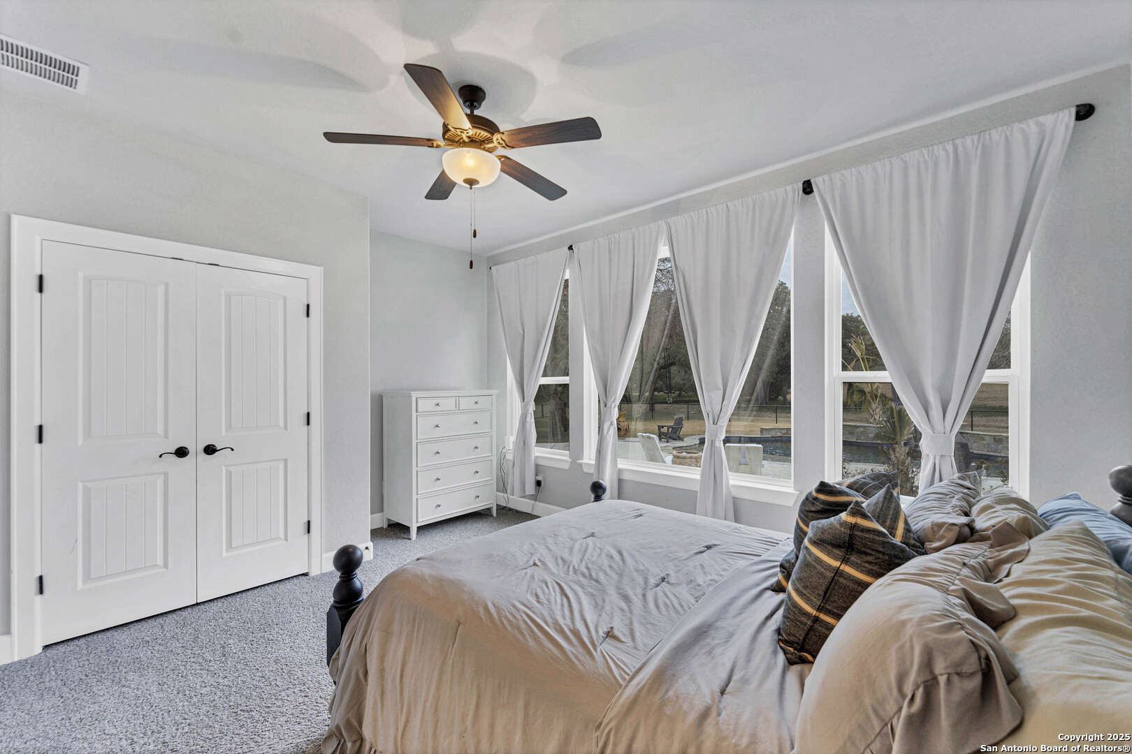 1033 Mystic Shores Boulevard Spring Branch, TX 78070 - Photo 13 of 39 a bedroom with a bed and a large window