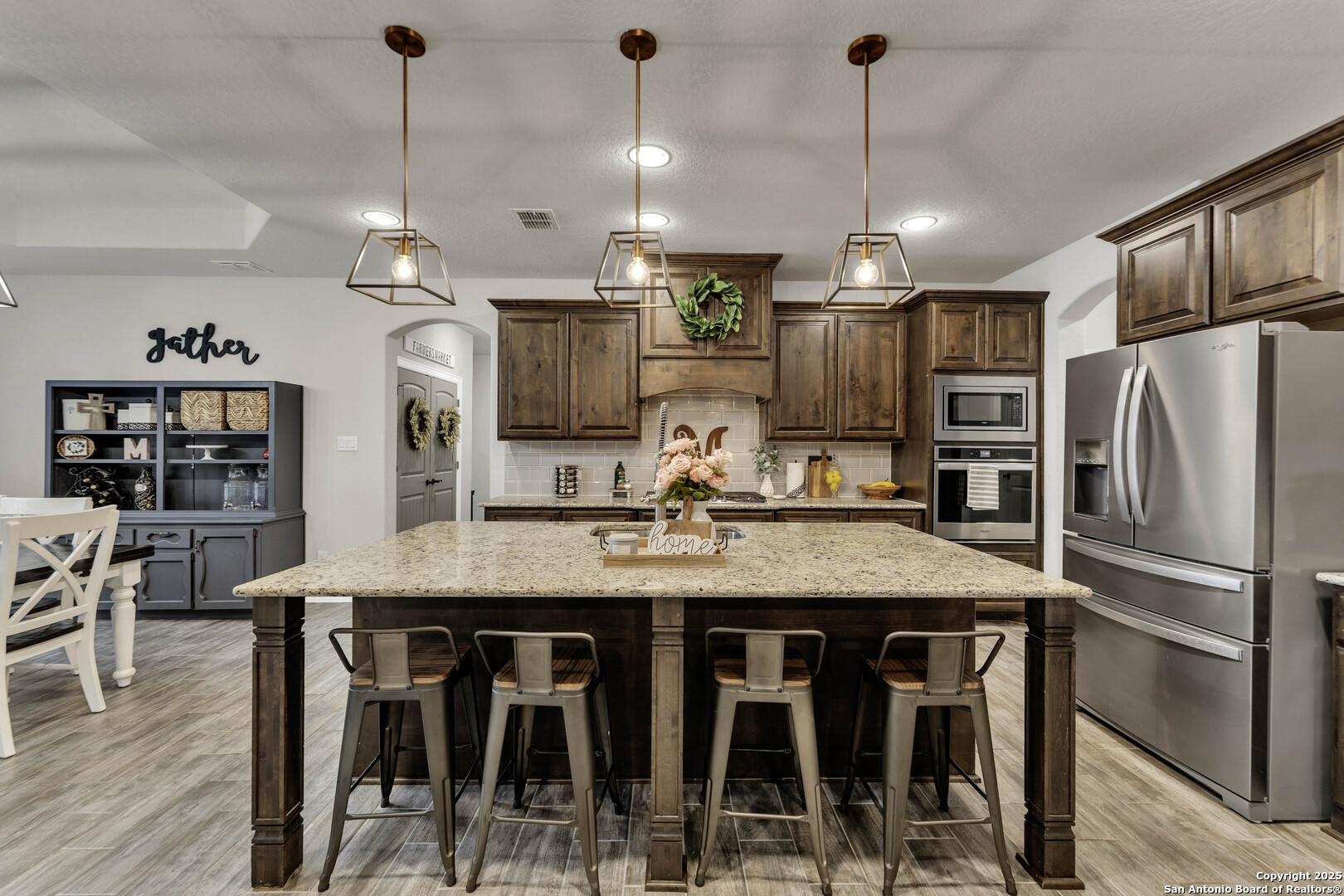 1033 Mystic Shores Boulevard Spring Branch, TX 78070 - Photo 15 of 39 a kitchen with stainless steel appliances granite countertop a kitchen island a stove a table and chairs