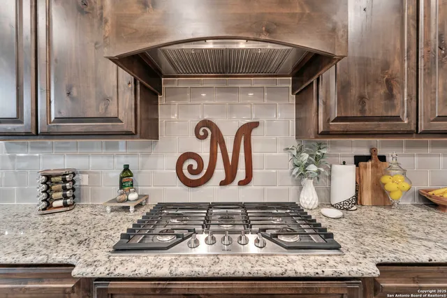a kitchen with granite countertop a stove and cabinets