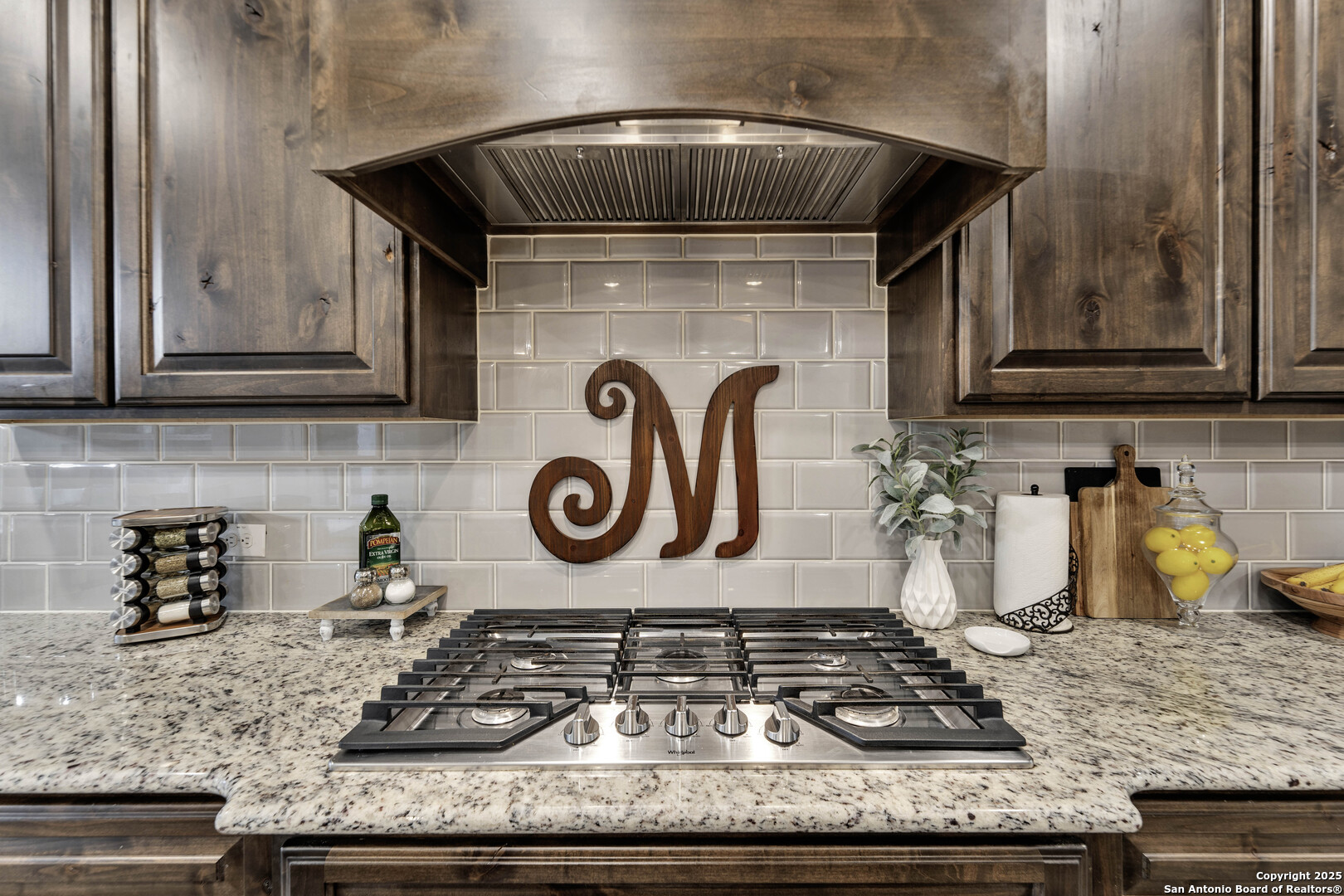 1033 Mystic Shores Boulevard Spring Branch, TX 78070 - Photo 16 of 39 a kitchen with granite countertop a stove and cabinets