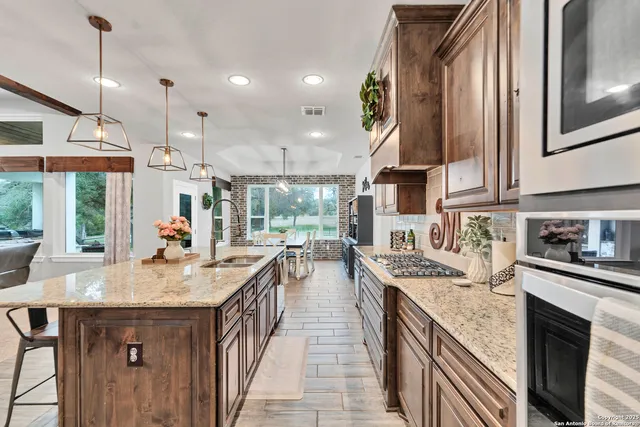a open kitchen with stainless steel appliances granite countertop a sink and a stove
