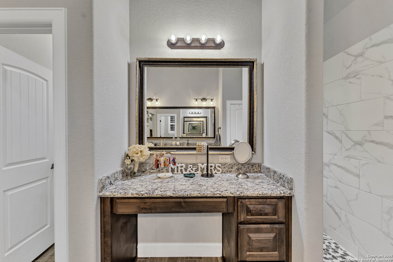 1033 Mystic Shores Boulevard Spring Branch, TX 78070 - Photo 25 of 39 a bathroom with a granite countertop sink and a mirror