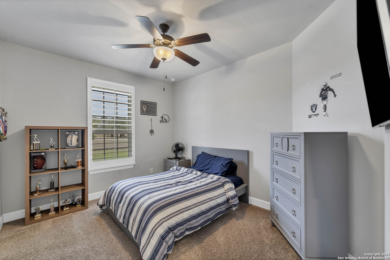 1033 Mystic Shores Boulevard Spring Branch, TX 78070 - Photo 29 of 39 a bedroom with a large bed and a chandelier