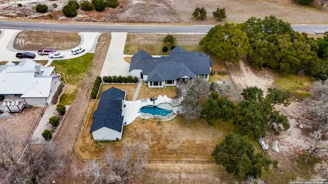an aerial view of a house with a swimming pool