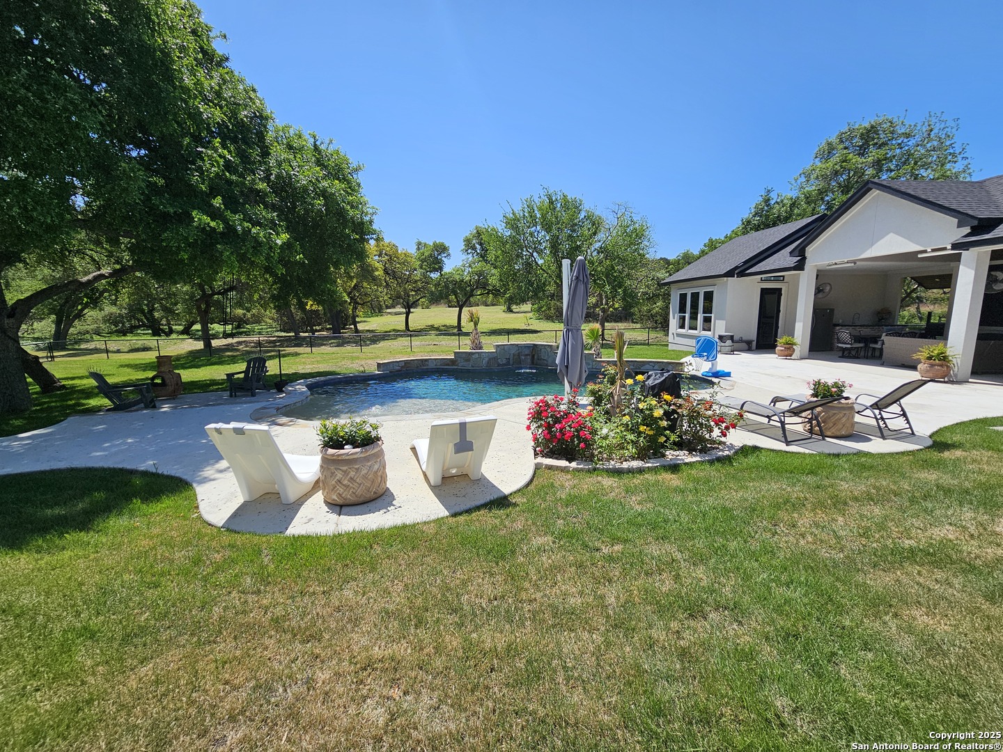 1033 Mystic Shores Boulevard Spring Branch, TX 78070 - Photo 31 of 39 a view of a house with backyard sitting area and garden