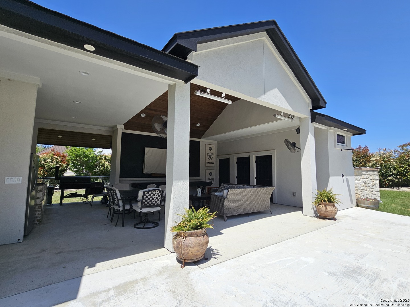 1033 Mystic Shores Boulevard Spring Branch, TX 78070 - Photo 35 of 39 a view of a patio with couches table and chairs and potted plants