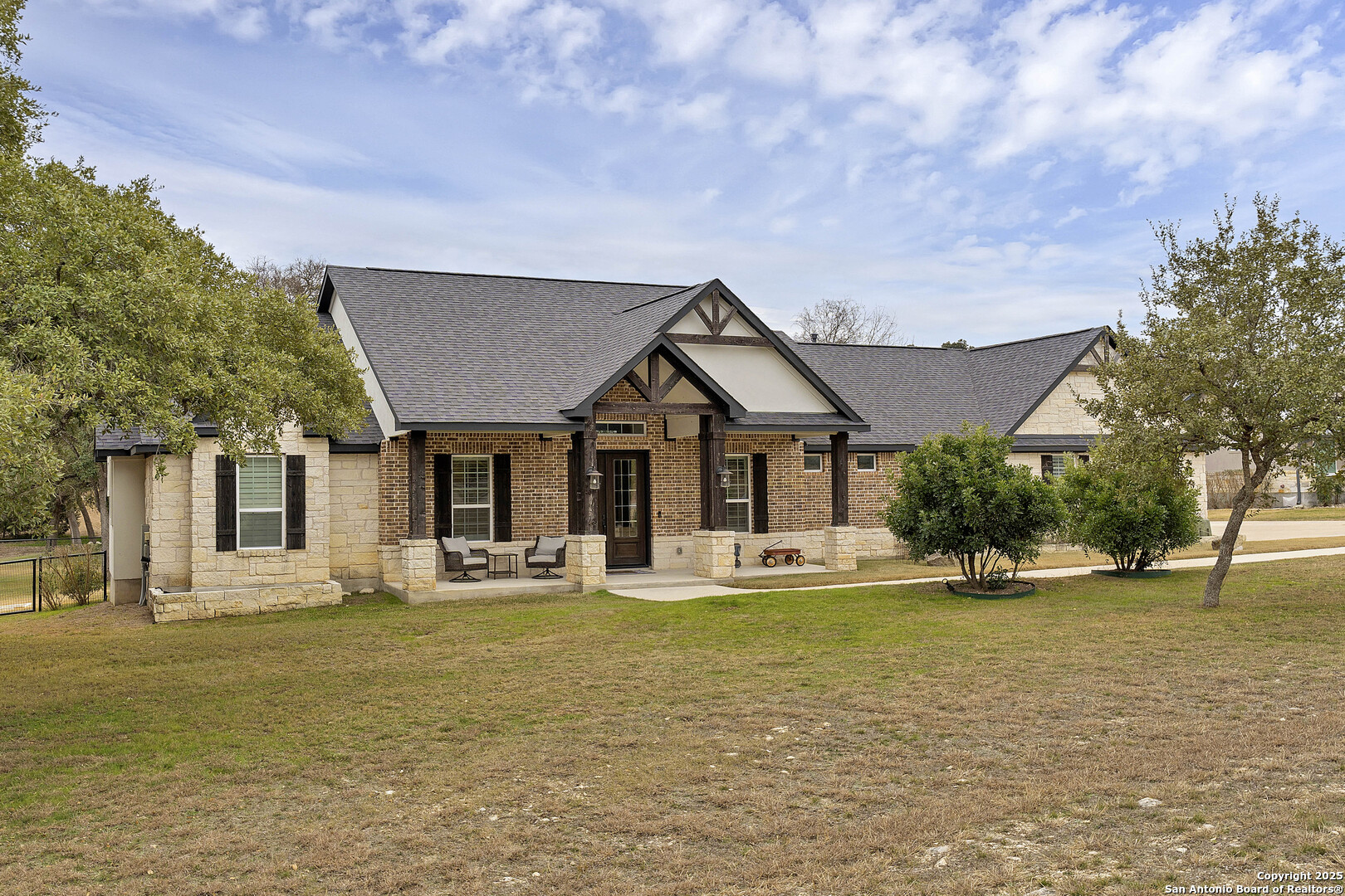 1033 Mystic Shores Boulevard Spring Branch, TX 78070 - Photo 7 of 39 a front view of a house with swimming pool and porch with green space