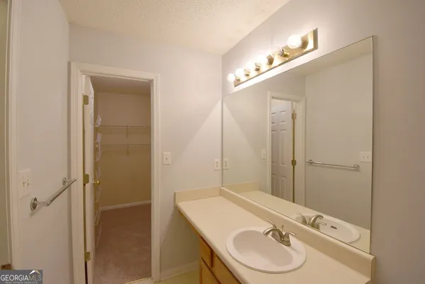 a bathroom with a sink vanity and a mirror