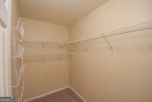 a bathroom with a granite countertop sink a toilet and a mirror