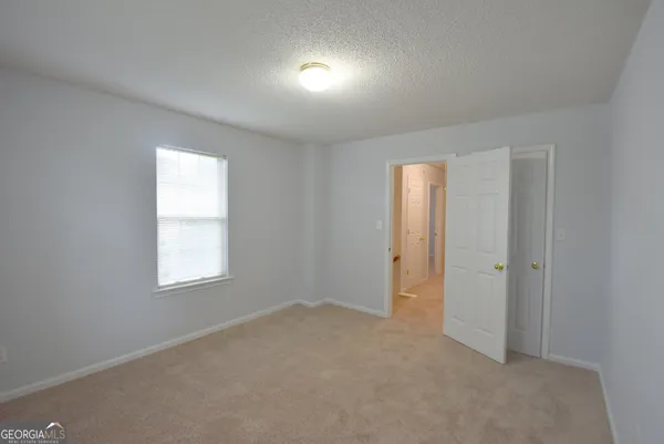 an empty room with windows and closet
