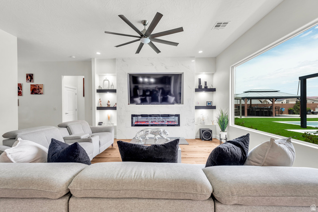 6105 Bunda Way St. George, UT 84790 - Photo 8 of 49 Living area featuring wood-finish flooring and a contemporary ceiling fan