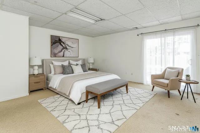 a bedroom with a bed and a chair