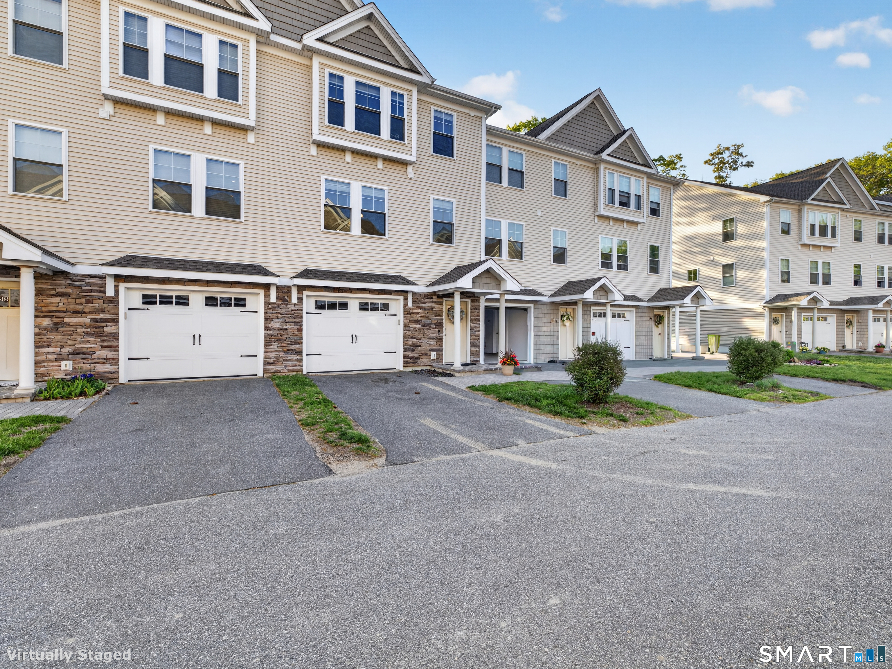 34 Village Crossing, Unit 34 Niantic, CT 06357 - Photo 1 of 38 a front view of a building with a road