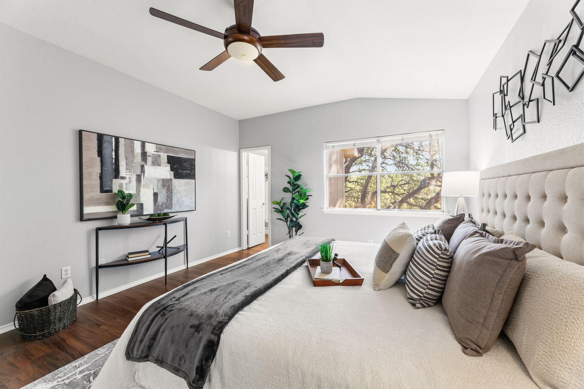 4609 Walsall Loop Austin, TX 78749 - Photo 16 of 39 Rich wood-inspired floors and a wide window with peaceful tree views anchor this bedroom.