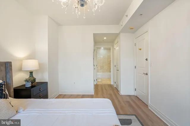 a bedroom with a bed and a potted plant