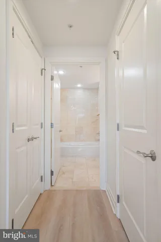 a bathroom with a sink a large mirror and a bathtub