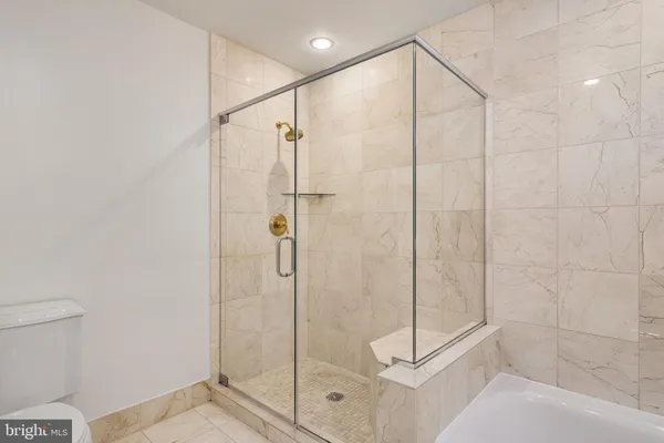 a bathroom with a bathtub and a shower