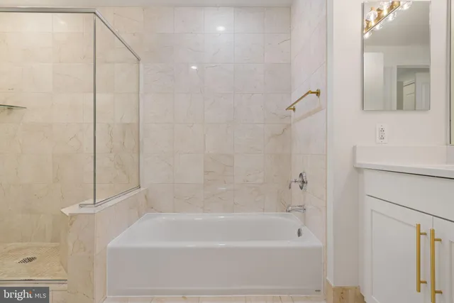 a bathroom with a bathtub and a shower