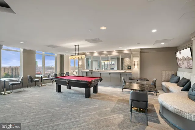 a room with pool table and windows