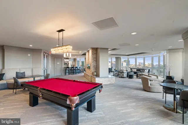 a living room with lots of furniture and a large window