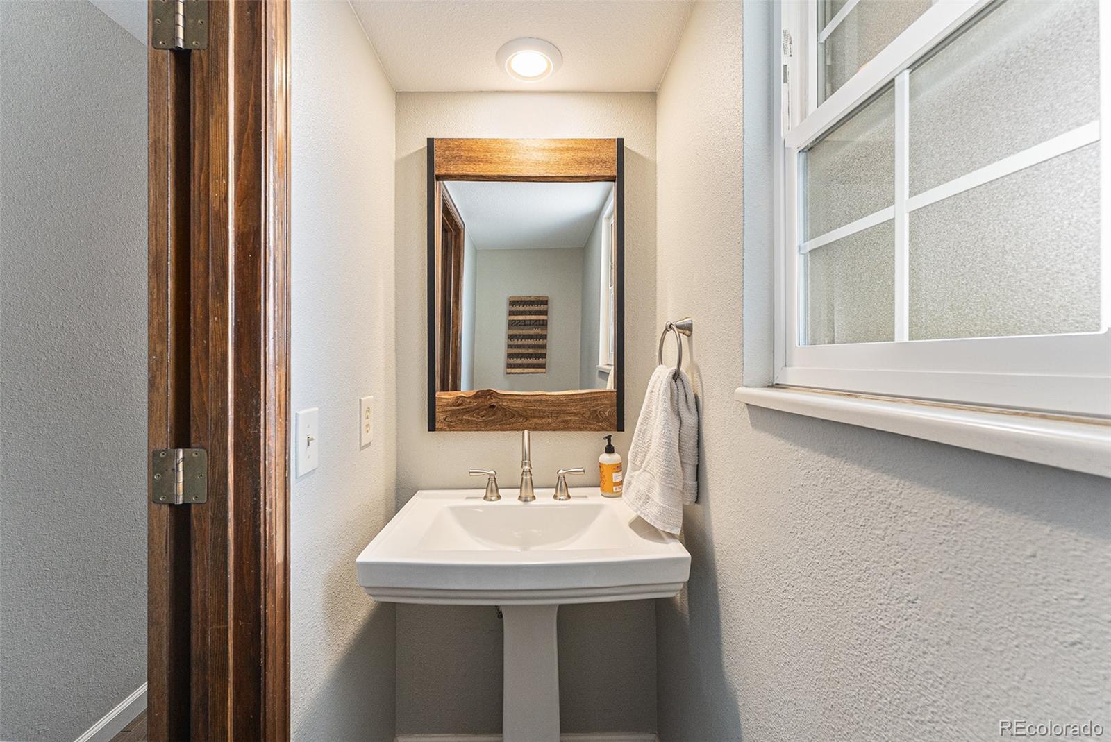 217 South Deframe Way Golden, CO 80401 - Photo 16 of 34 a bathroom with a sink and a mirror